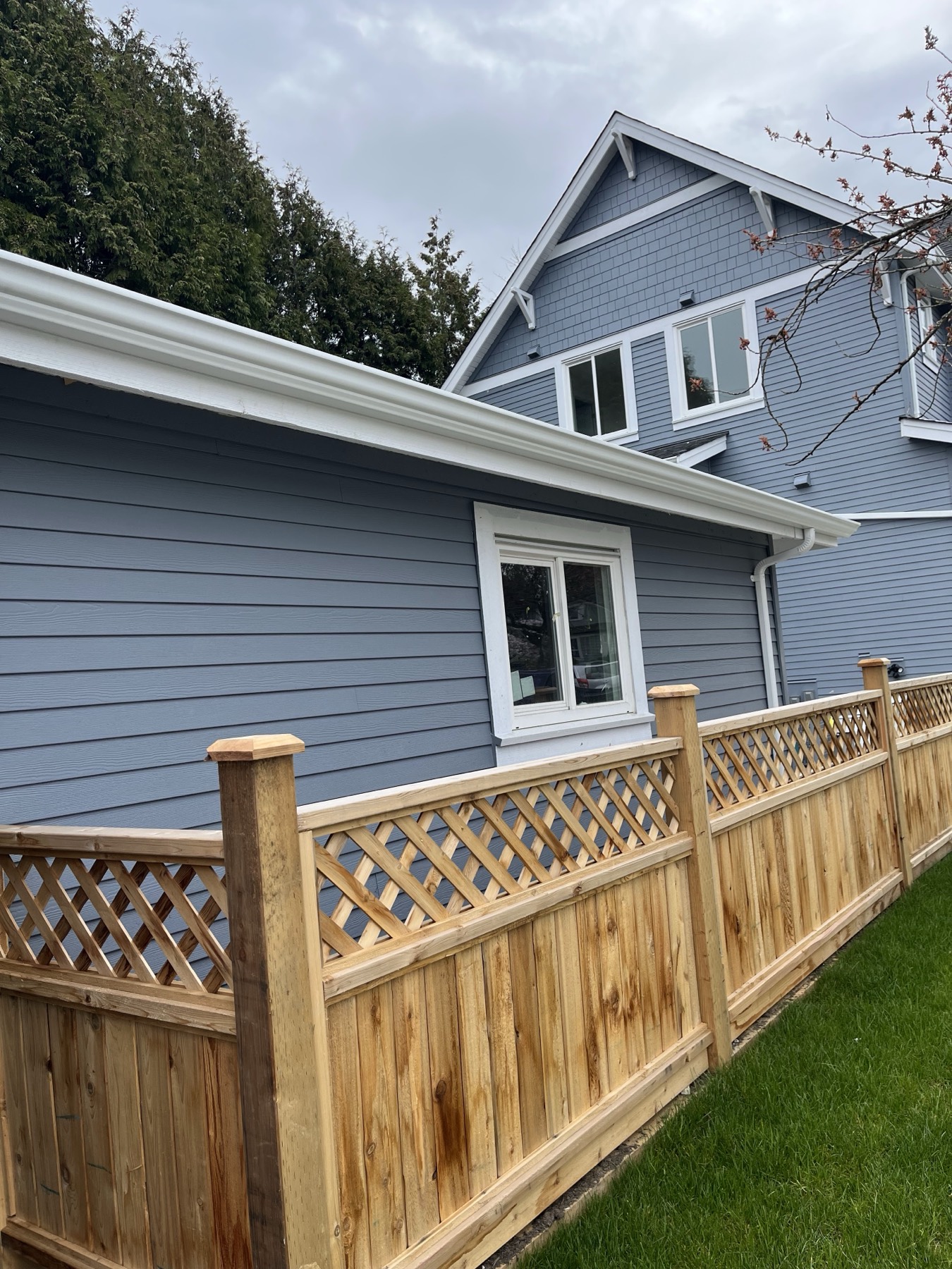 Grey siding beside a cedar fence
