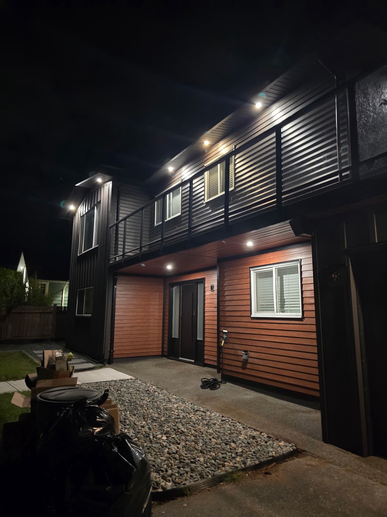 A modern home exterior lit at night